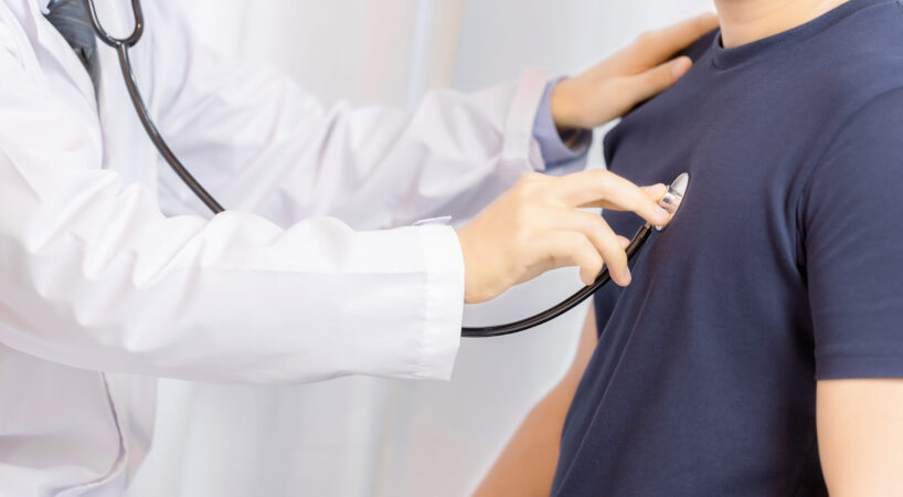 Doctor examination young man with stethoscope in hospital. healt